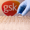 Juckreiz: GSK verkauft Wirkstoffkandidat Foto: Eine Hand mit Einweghandschuhen hebt eines von vielen leeren Vials hoch.